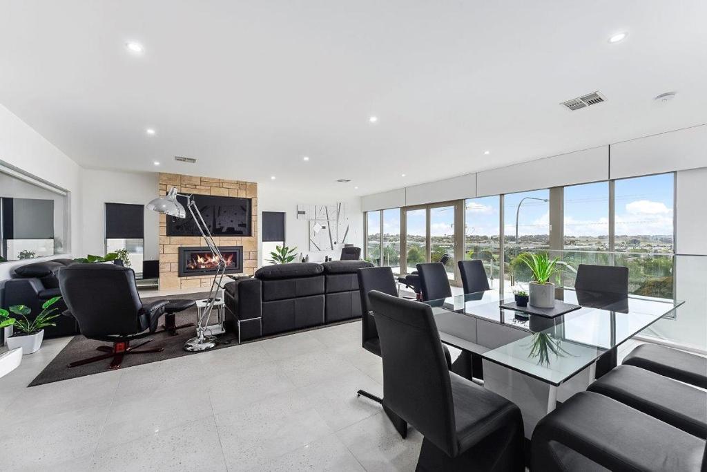 a living room with a couch and a table and chairs at KENNEDY EXECUTIVE TOWNHOUSE in Mount Gambier