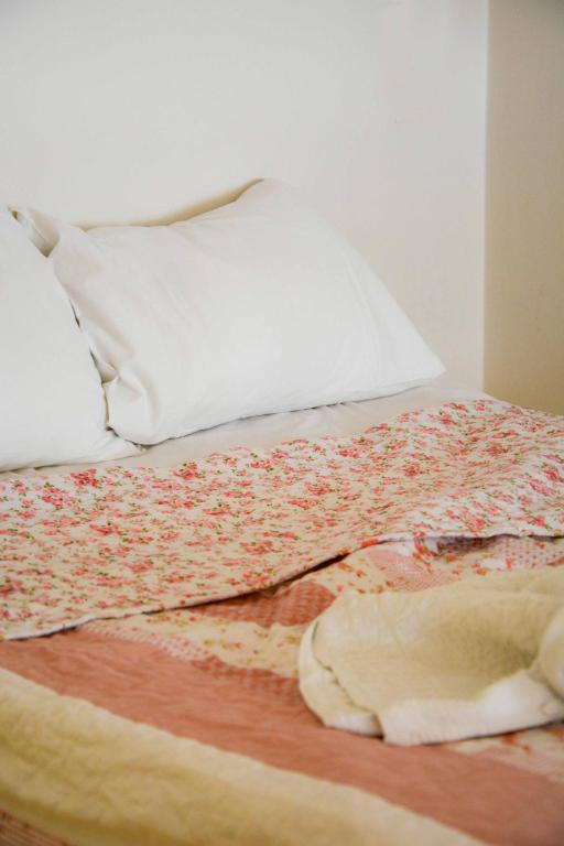 A bed or beds in a room at Kleio House