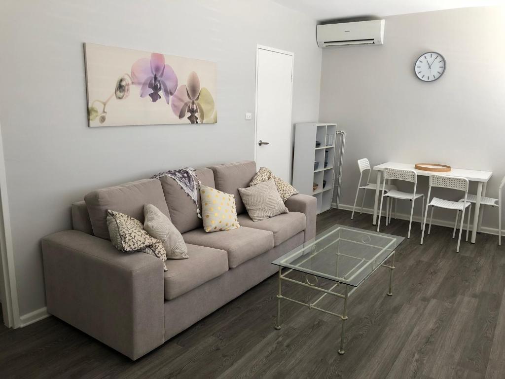 a living room with a couch and a table at 1 Bedroom Unit in Heart of Elsternwick in Melbourne