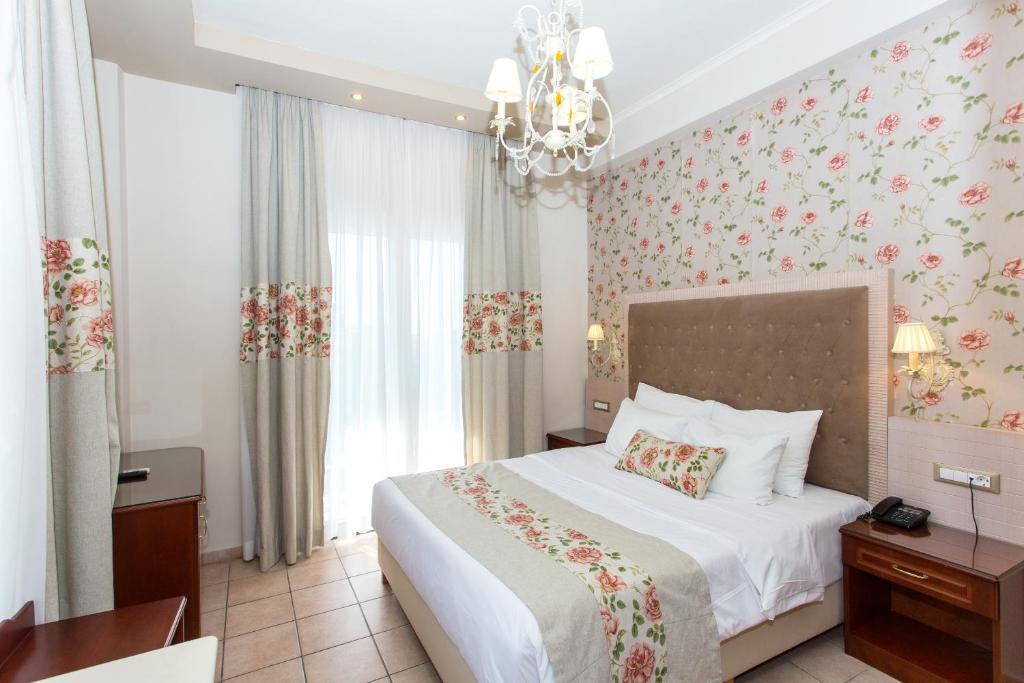 Postel nebo postele na pokoji v ubytování Olympic Hotel