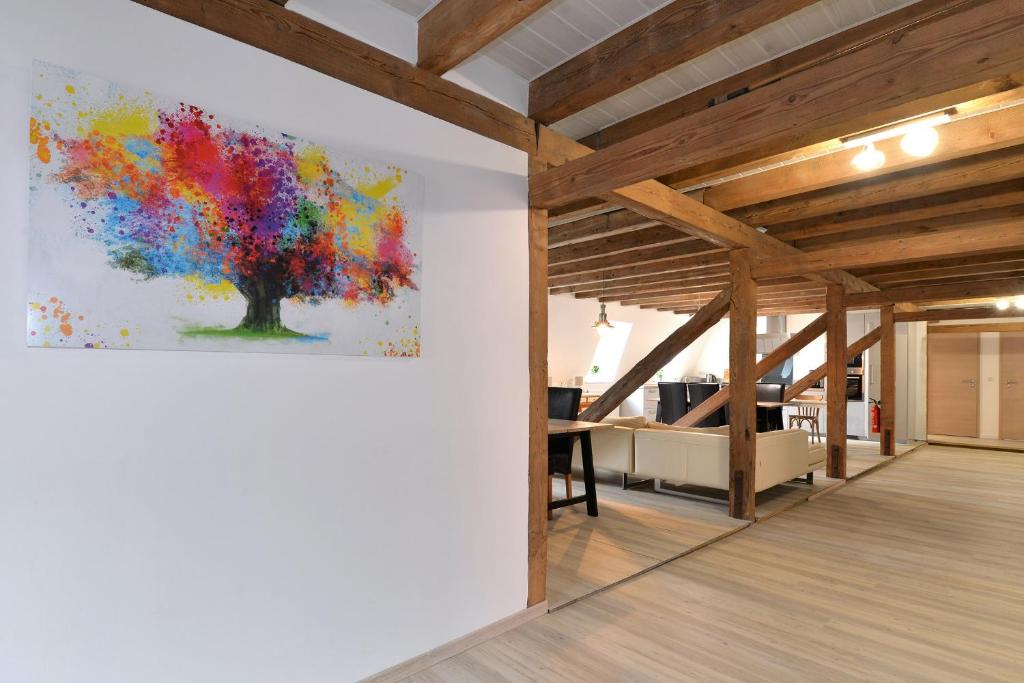 a painting of a tree on a wall in an office at Les copains d'abord in Sondernach