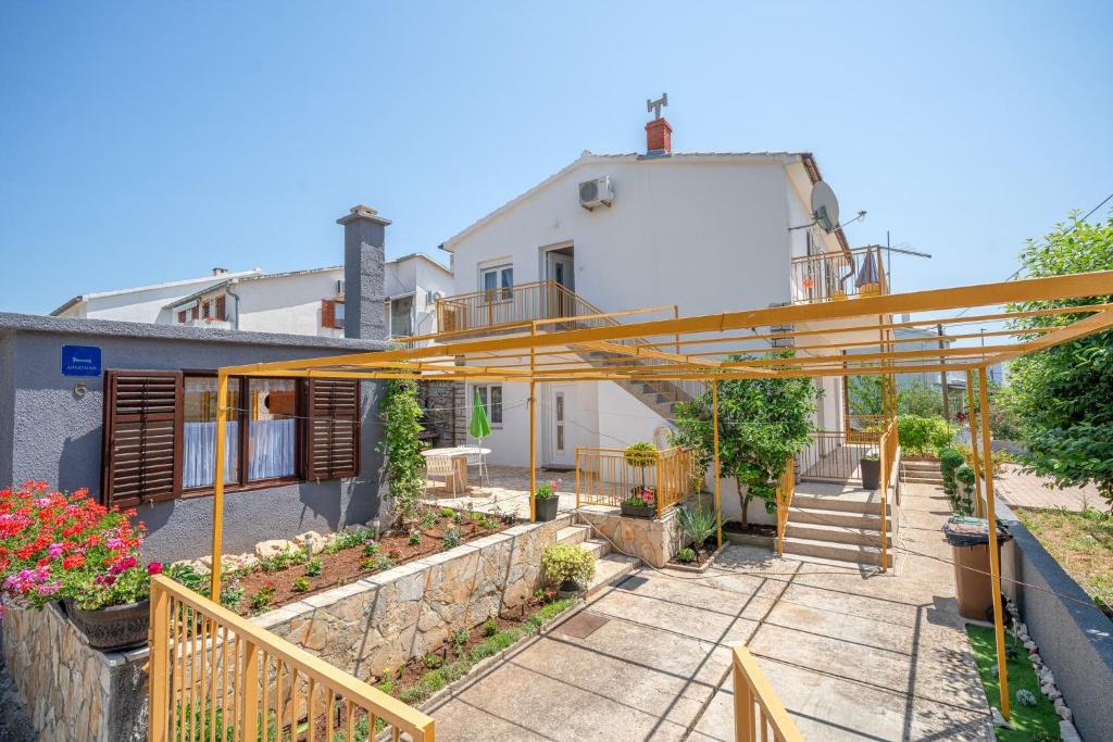 a view of a house with a yellow structure at Apartments Klavdija in Vodice