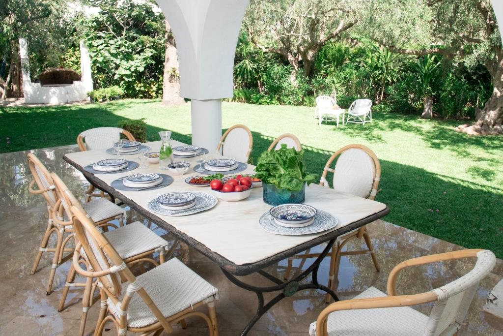 a table with plates and bowls of fruit on a patio at Villa"Dar Janna" in Hammamet
