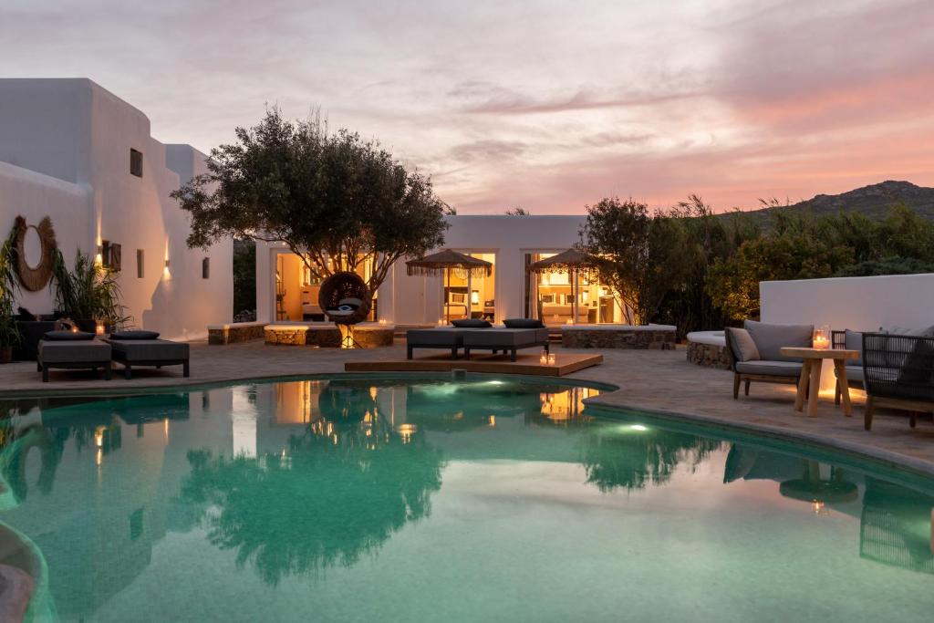 a swimming pool in the middle of a house at Olive Mykonos Villas in Ano Mera