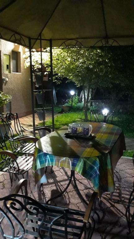 a table with a table cloth on top of it at Viola i Detelina Apartments in Perućac