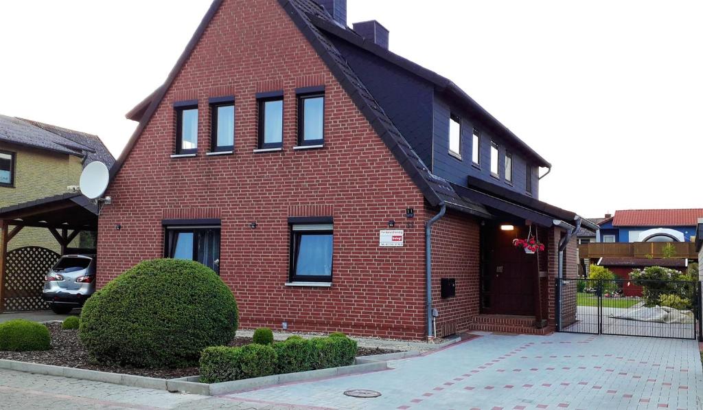 a red brick house with a black roof at Am Mariental 11 in Hankensbüttel