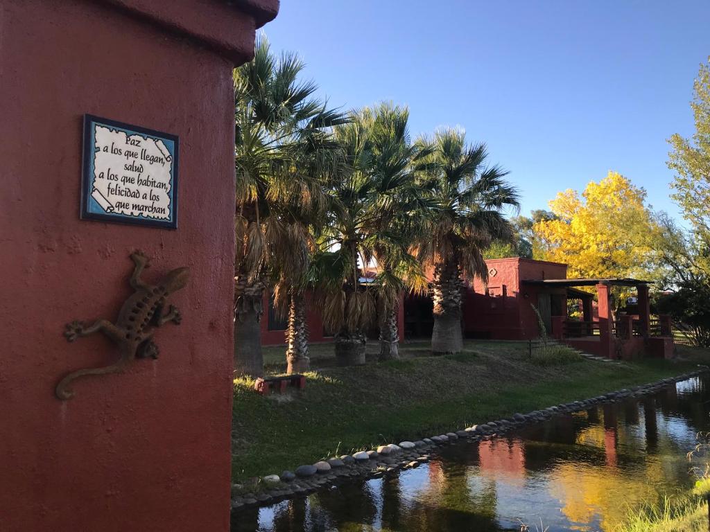 a clock on the side of a building next to a river at Finca Silvestre in San Rafael