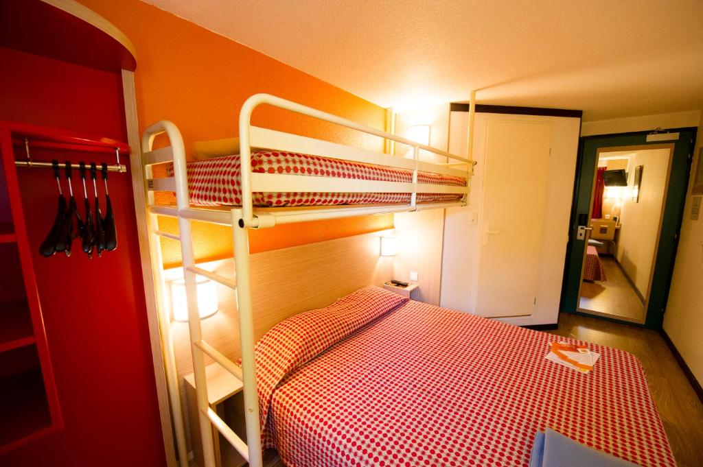 a small bedroom with a bunk bed and a ladder at Premiere Classe Orleans Ouest - La Chapelle St Mesmin in La Chapelle-Saint-Mesmin