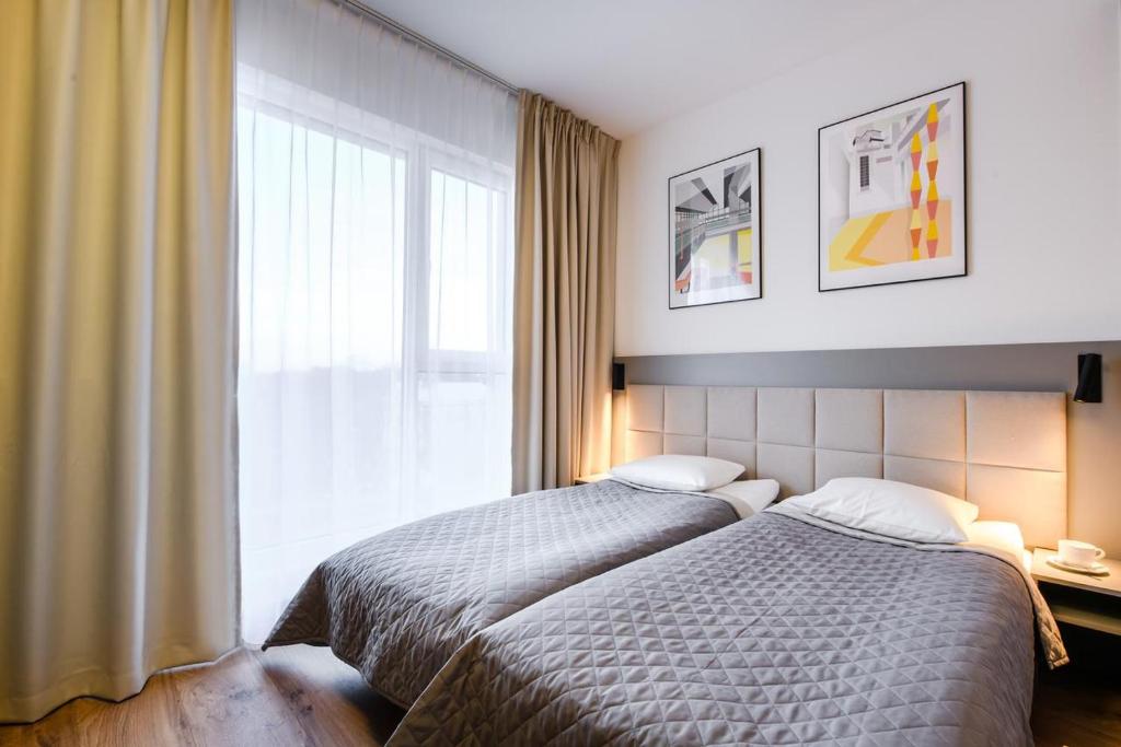 Posteľ alebo postele v izbe v ubytovaní Apartments "Wolska Residence"