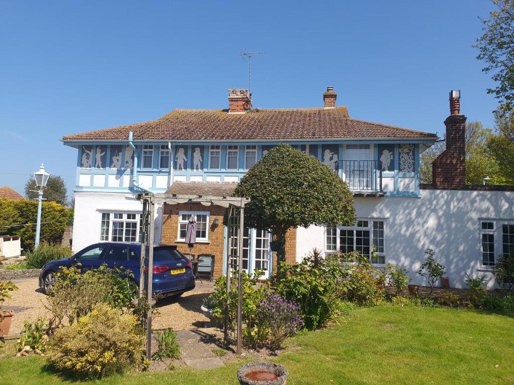 a house with a car parked in front of it at Old Coach House in Birchington