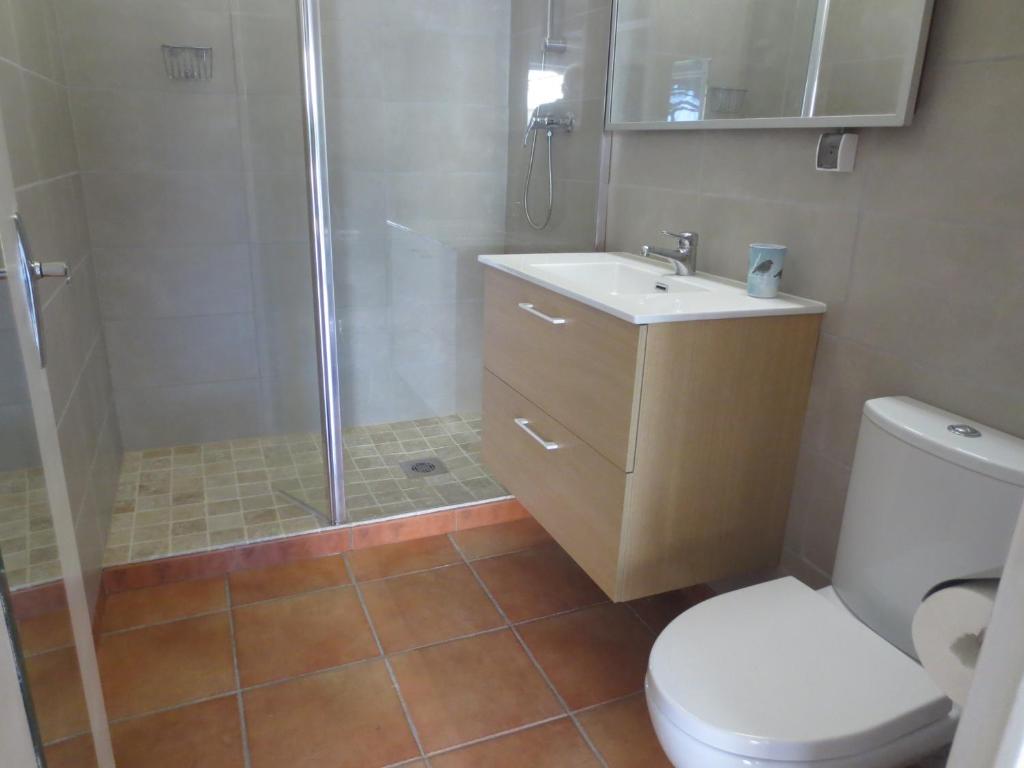 a bathroom with a shower and a sink and a toilet at Chevalier in Saint-Nazaire