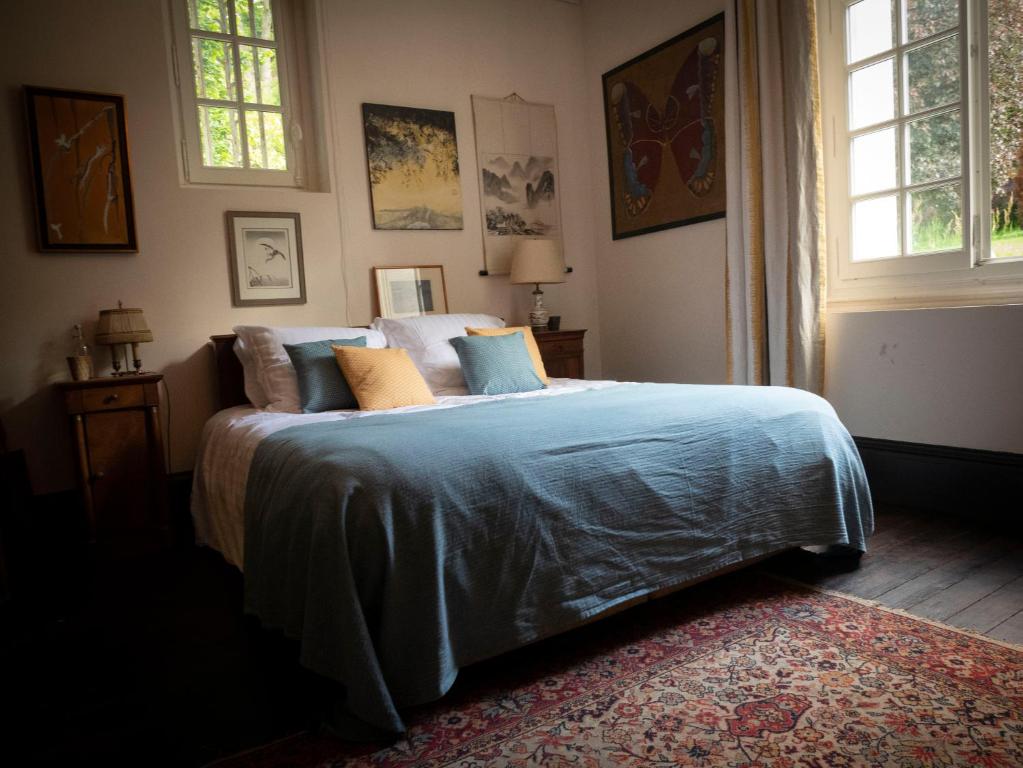 - une chambre avec un lit doté de draps et d'oreillers bleus dans l'établissement Bed & Breakfast - La closerie de la Fuye, à Ballan-Miré