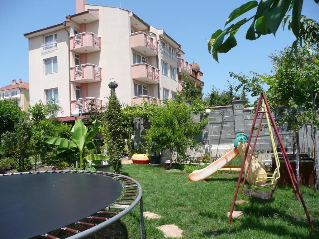 a playground in front of a building with a slide at Dimitrovi Guest House in Aheloy