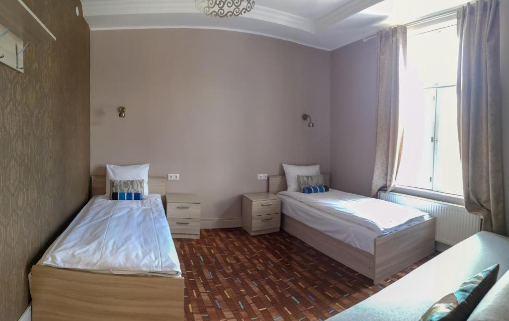 Postel nebo postele na pokoji v ubytování Villa Kadriorg Hostel