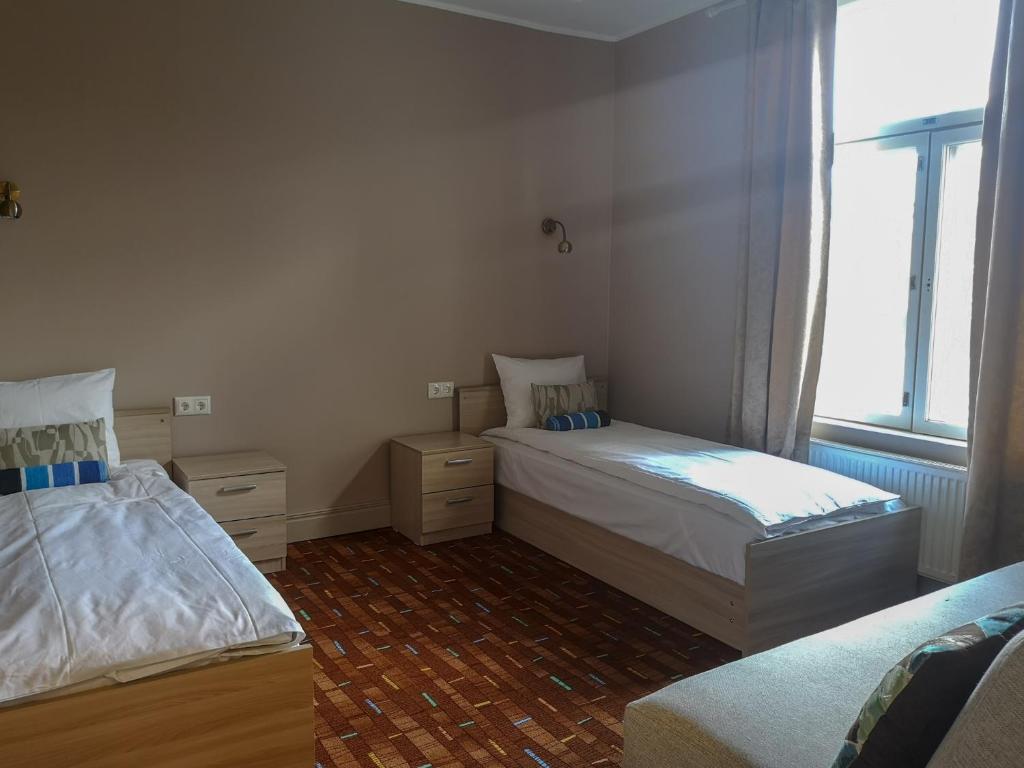 Postel nebo postele na pokoji v ubytování Villa Kadriorg Hostel