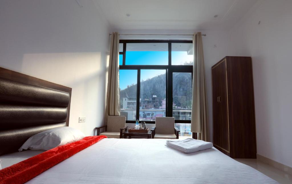 Ένα ή περισσότερα κρεβάτια σε δωμάτιο στο Hotel Tapovan Cottage