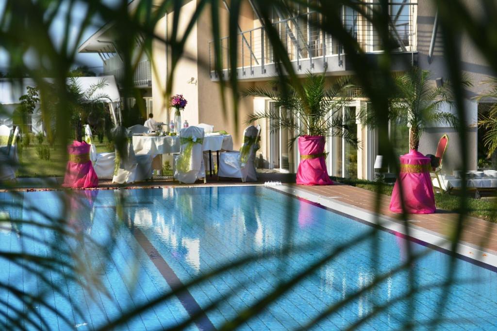 a swimming pool with pink decorations in a building at Szépia Bio and Art Hotel in Zsámbék