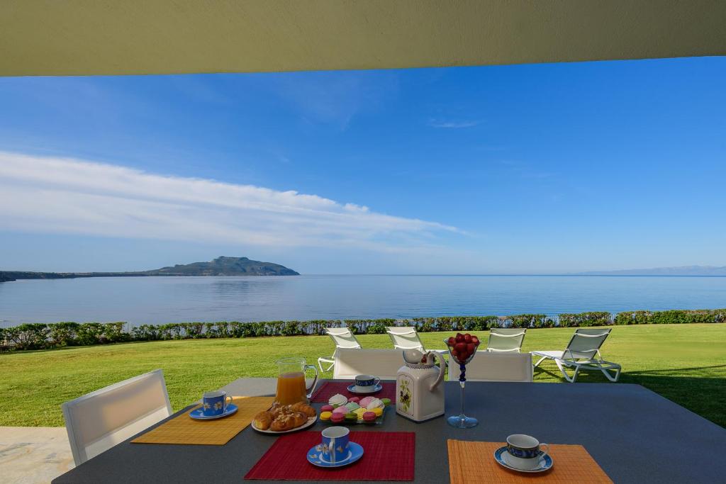 a dining table with a view of the ocean at Finisia House in Elia Laconias