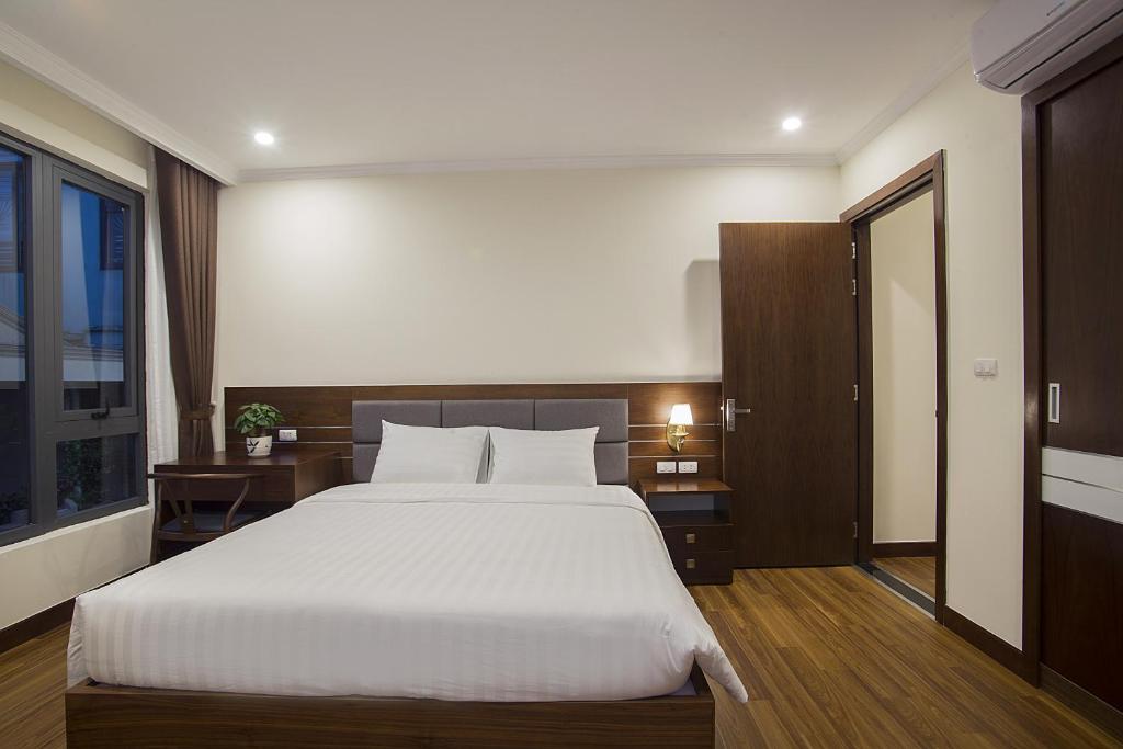 Postel nebo postele na pokoji v ubytování Newsky Serviced Apartment
