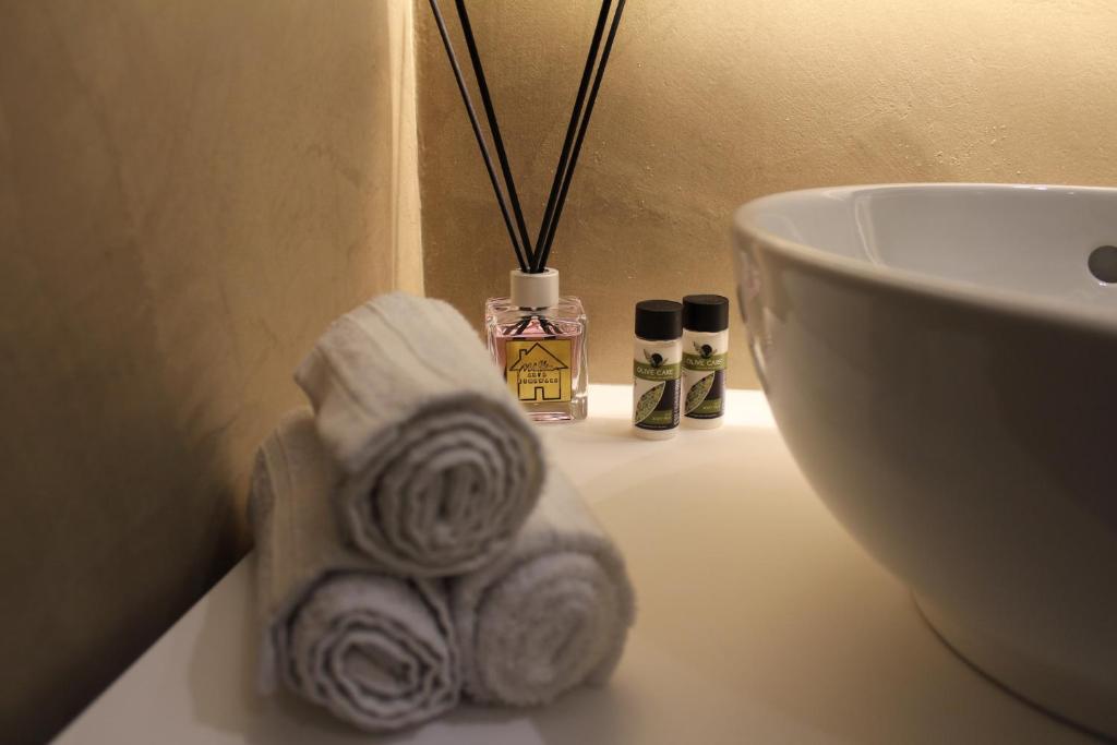 a towel on a bathroom counter next to a sink at Theater Penthouse in Corfu Town
