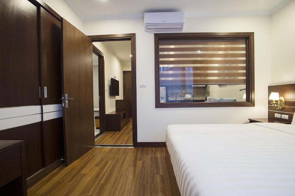 Postel nebo postele na pokoji v ubytování Newsky Serviced Apartment