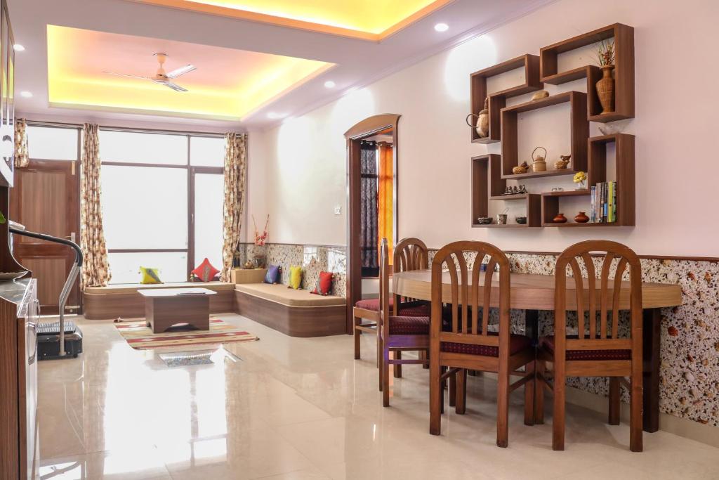 a living room with a dining room table and chairs at Sai Alok homestay in Shimla
