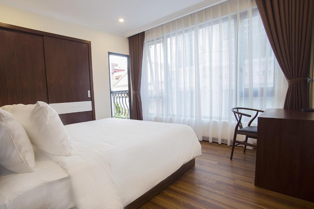 Postel nebo postele na pokoji v ubytování Newsky Serviced Apartment