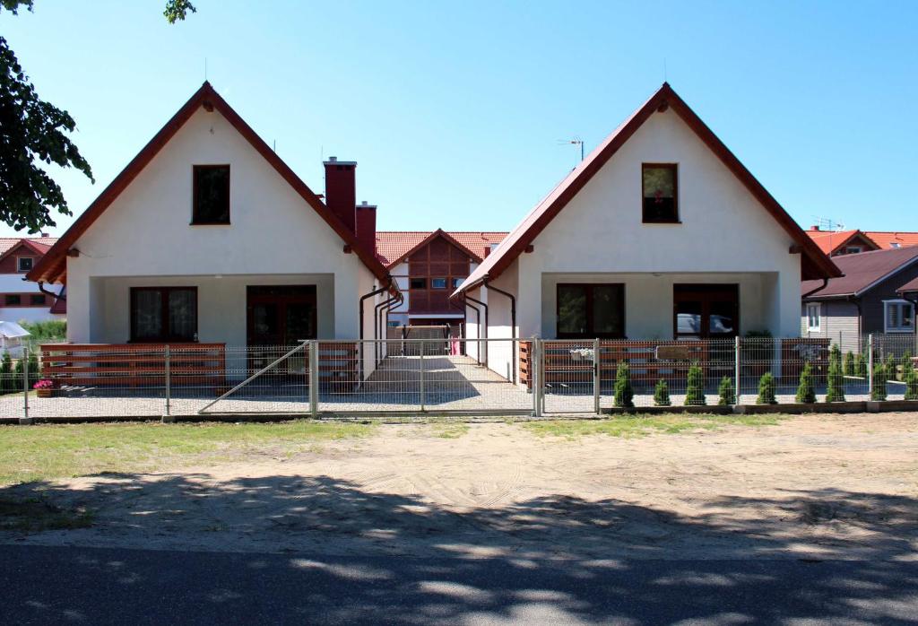 ŻarnowskaにあるU Przyjaciółの赤屋根の大白い家
