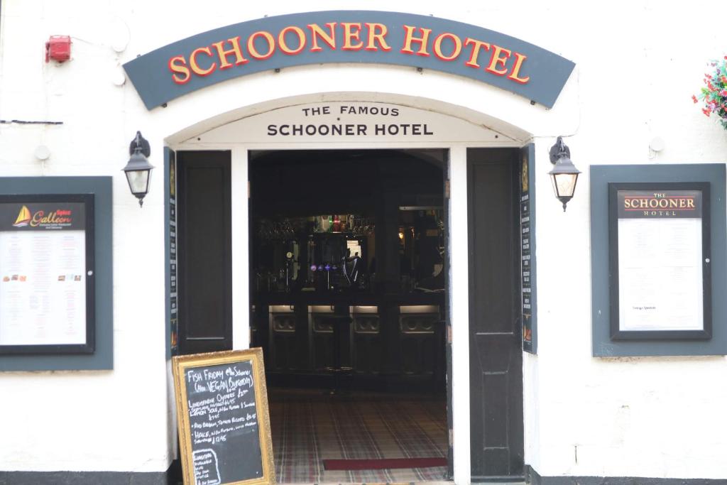 a doorway to a school house with a sign in front at Schooner Hotel in Alnmouth