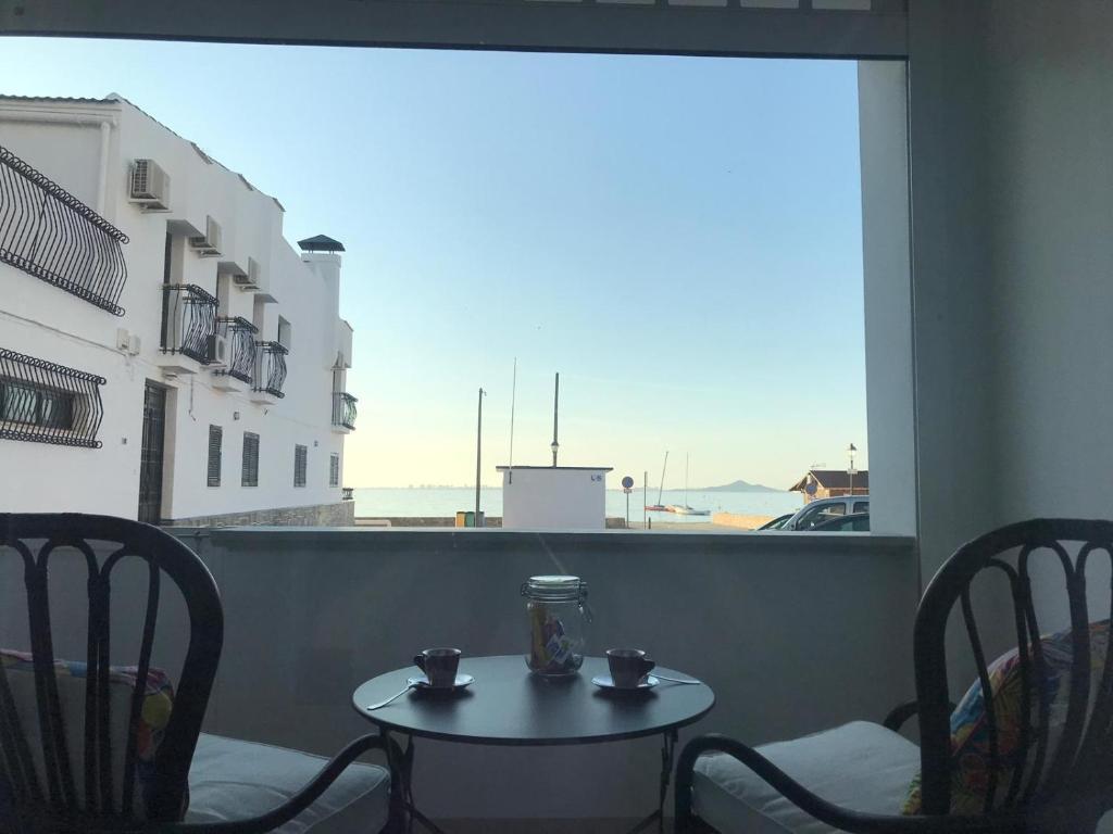 een tafel en stoelen met uitzicht op een balkon bij The Fisherman’s House in Los Alcázares