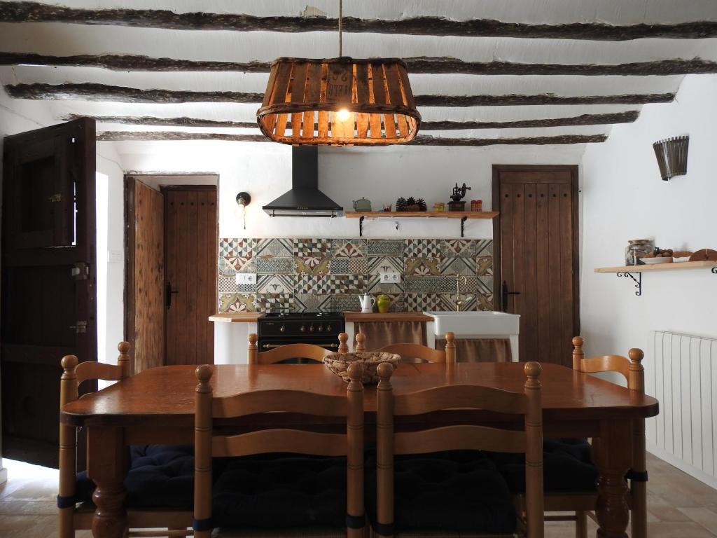 comedor con mesa de madera y techo en CASA RURAL REVOLCADORES en Moratalla