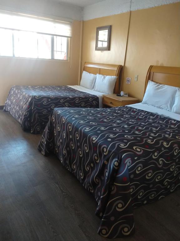 Postel nebo postele na pokoji v ubytování Hotel Boulevard Mexicali