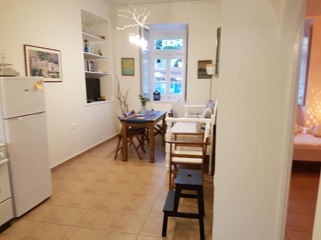 a kitchen and dining room with a table and chairs at Hydra Memories House in Hydra