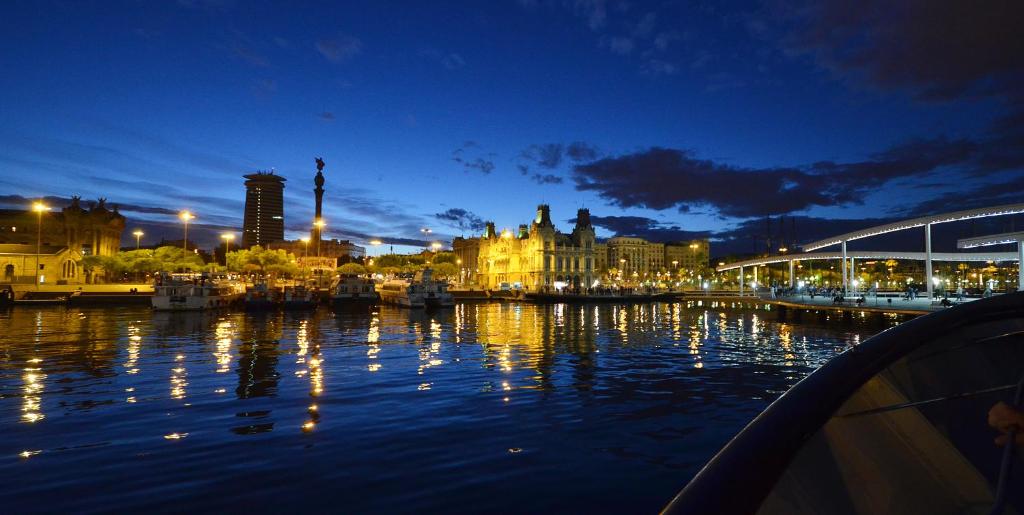 a city at night with lights on the water at Southern Cross in Barcelona