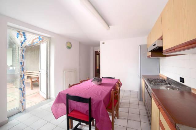 a kitchen with a table with a pink table cloth on it at Villa Nino Bixio in Bellaria-Igea Marina