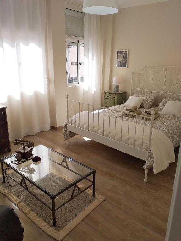 a bedroom with a bed and a glass table at Made in You - Oporto Guesthouse in Porto