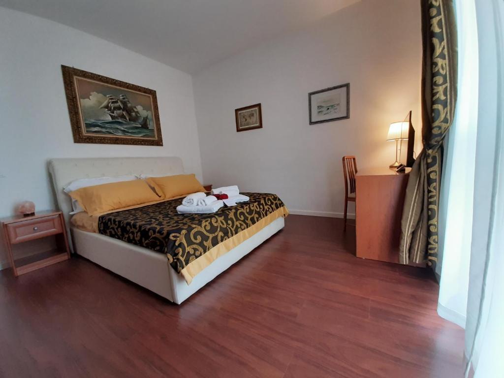 a bedroom with a bed and a wooden floor at Carpe Diem Ancona in Ancona