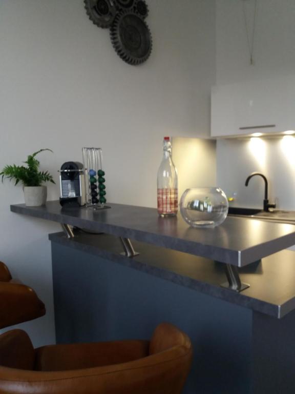 a kitchen with a counter top with a sink and a sink at L' ALBATROS vue sur le port in Fécamp