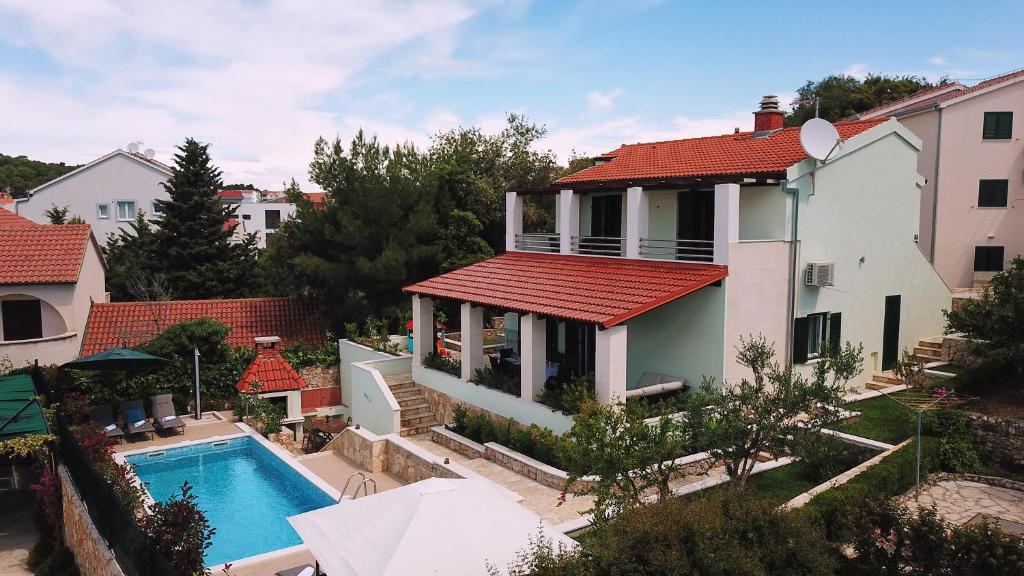 a villa with a swimming pool and a house at Villa Marina in Ražanj