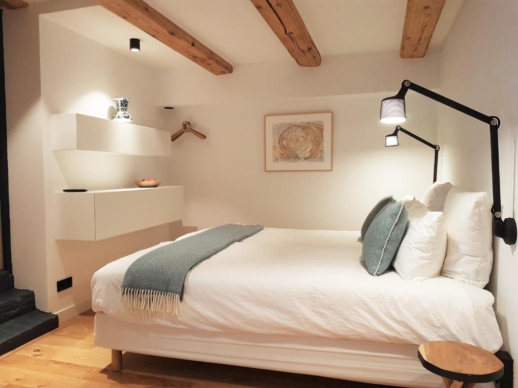 a bedroom with a bed and a lamp on the wall at 23 SouS in Amsterdam