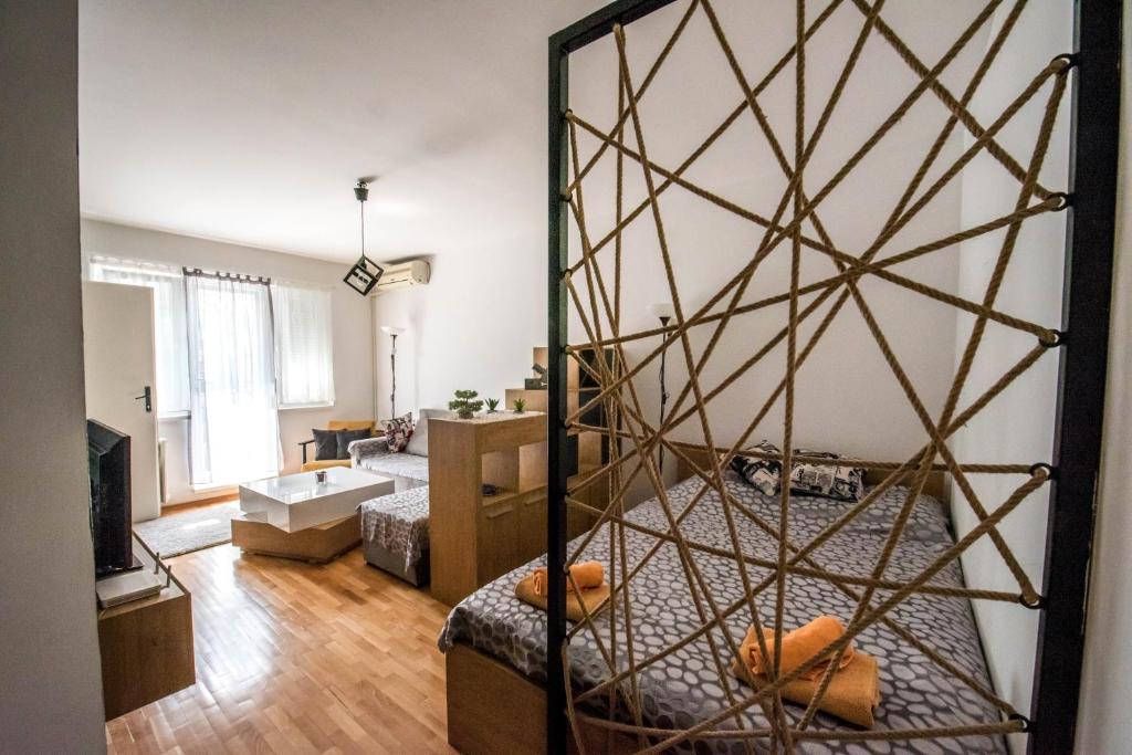 a living room with a bed with a glass wall at La Vecchia Signora APARTMENT in Skopje