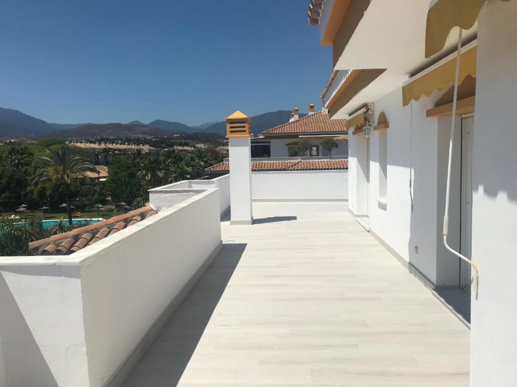 a balcony of a house with white walls and a view at Puerto Banus Luxury Penthouse in Marbella