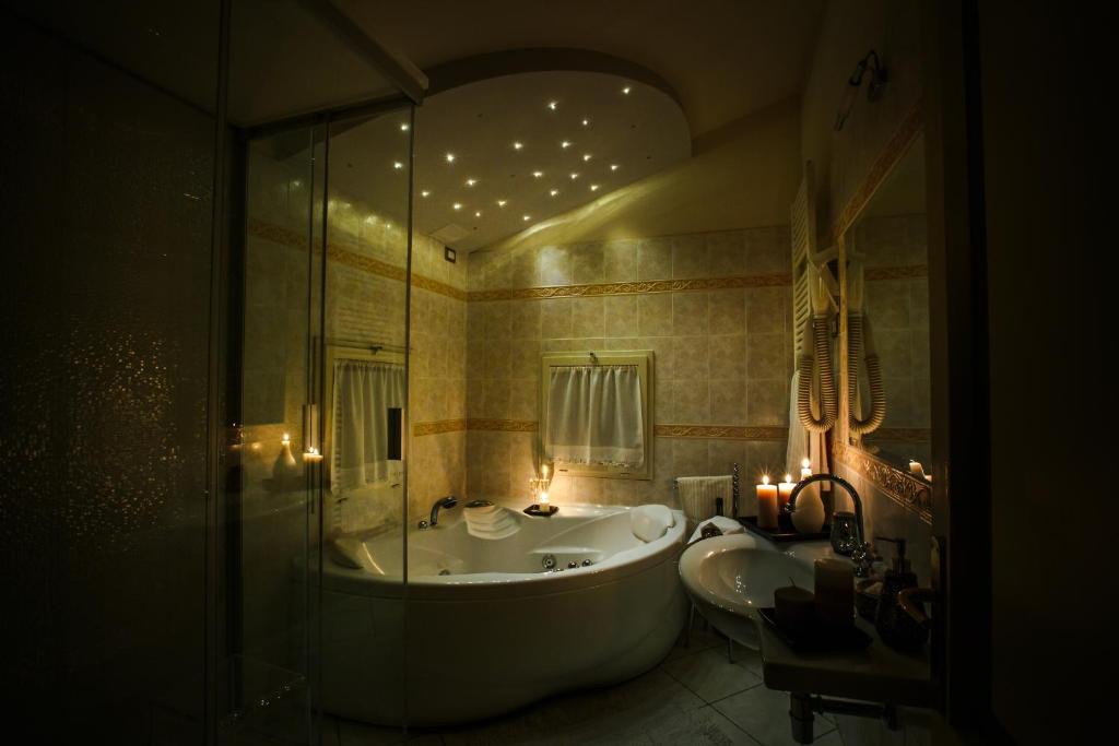 a bathroom with a tub and a sink and a shower at Villa Nuba,con private SPA room in Perugia
