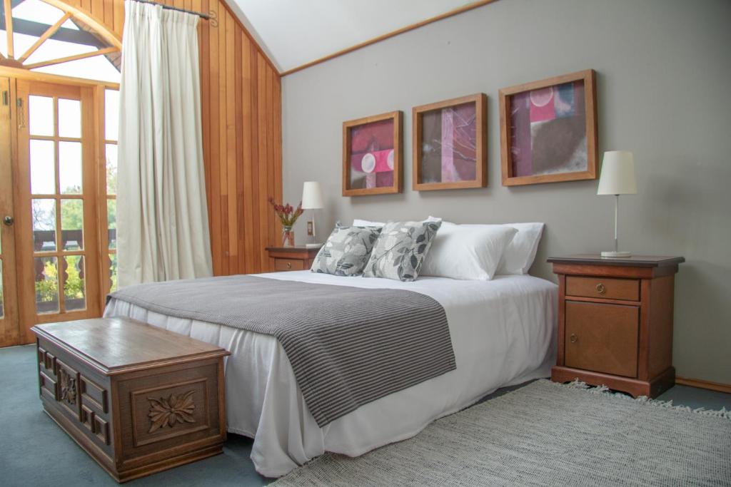 sypialnia z dużym łóżkiem i oknem w obiekcie Hotel Casa Marron w mieście Villarrica