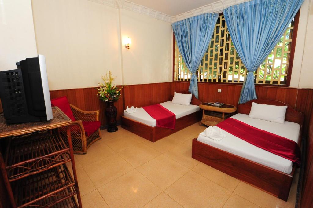 Postel nebo postele na pokoji v ubytování Okay Guesthouse Phnom Penh
