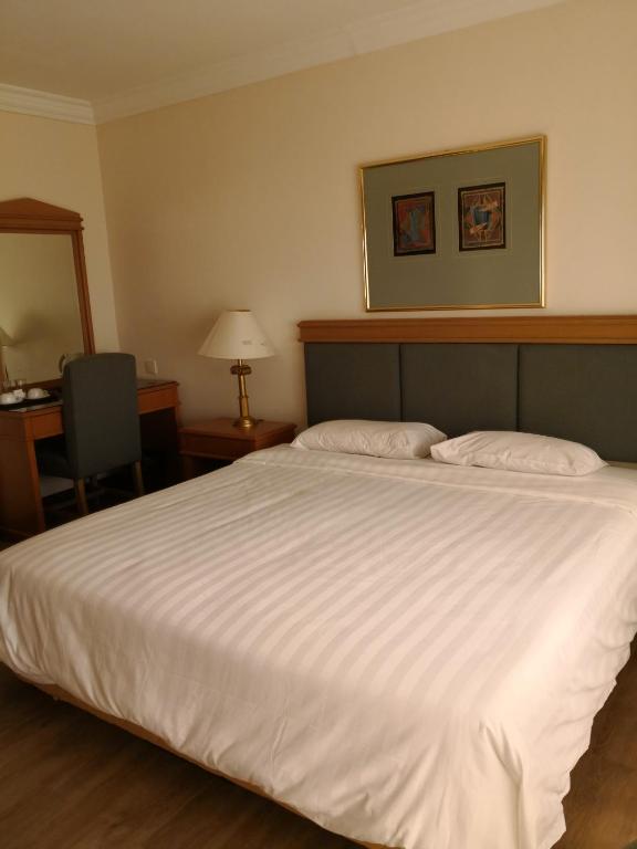 Postel nebo postele na pokoji v ubytování The Executive Hotel Lahad Datu