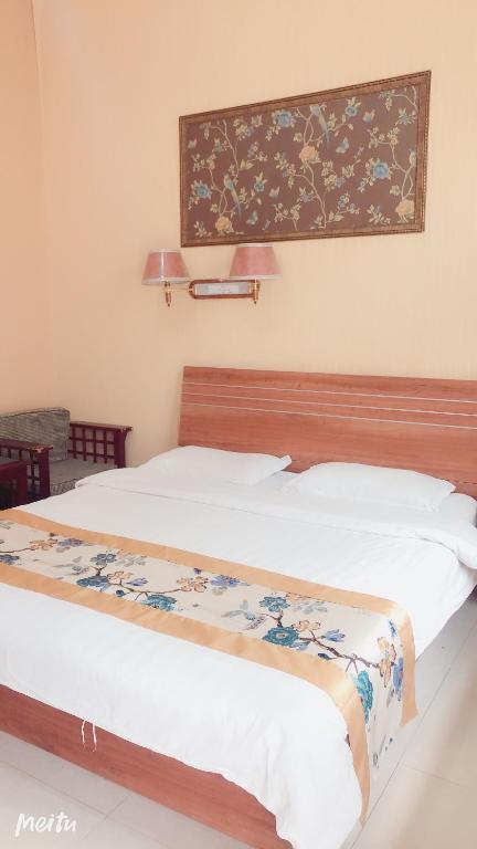 Postel nebo postele na pokoji v ubytování Huashan Gehui Hotel
