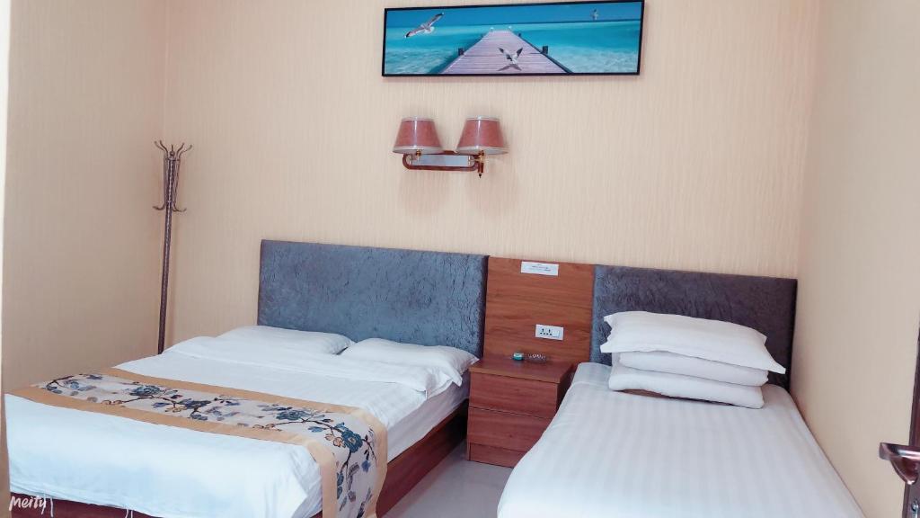 Postel nebo postele na pokoji v ubytování Huashan Gehui Hotel