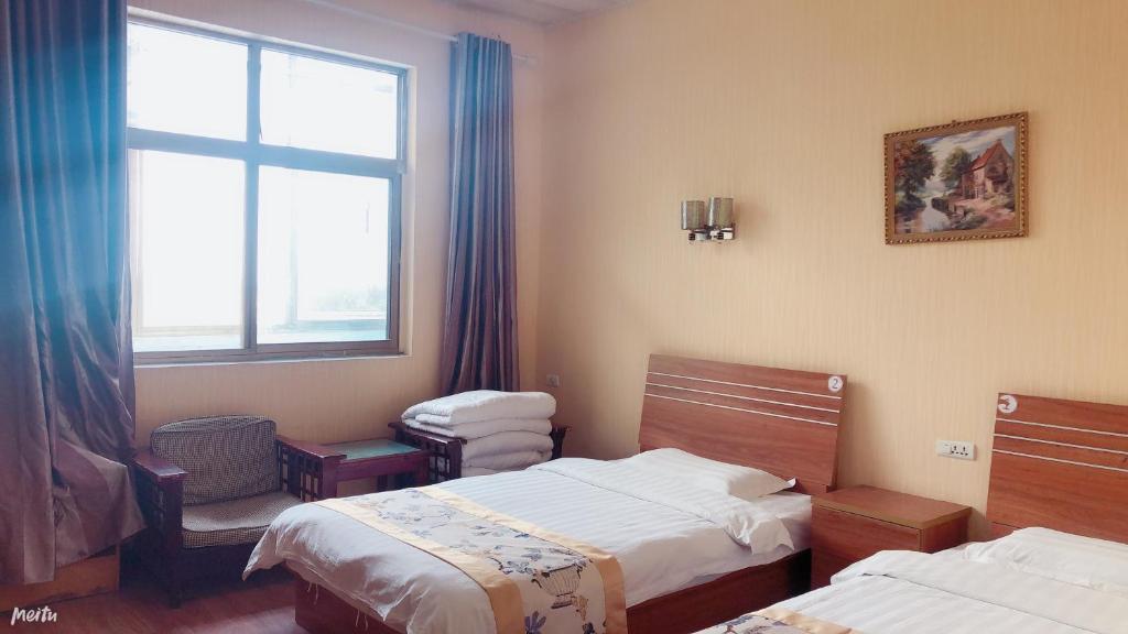 Postel nebo postele na pokoji v ubytování Huashan Gehui Hotel