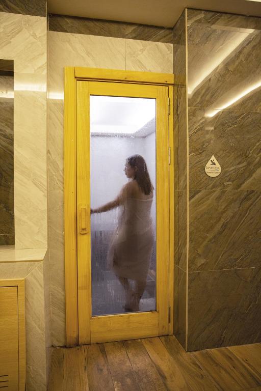a woman standing behind a door in a room at Premier Vista Hotel in Silivri